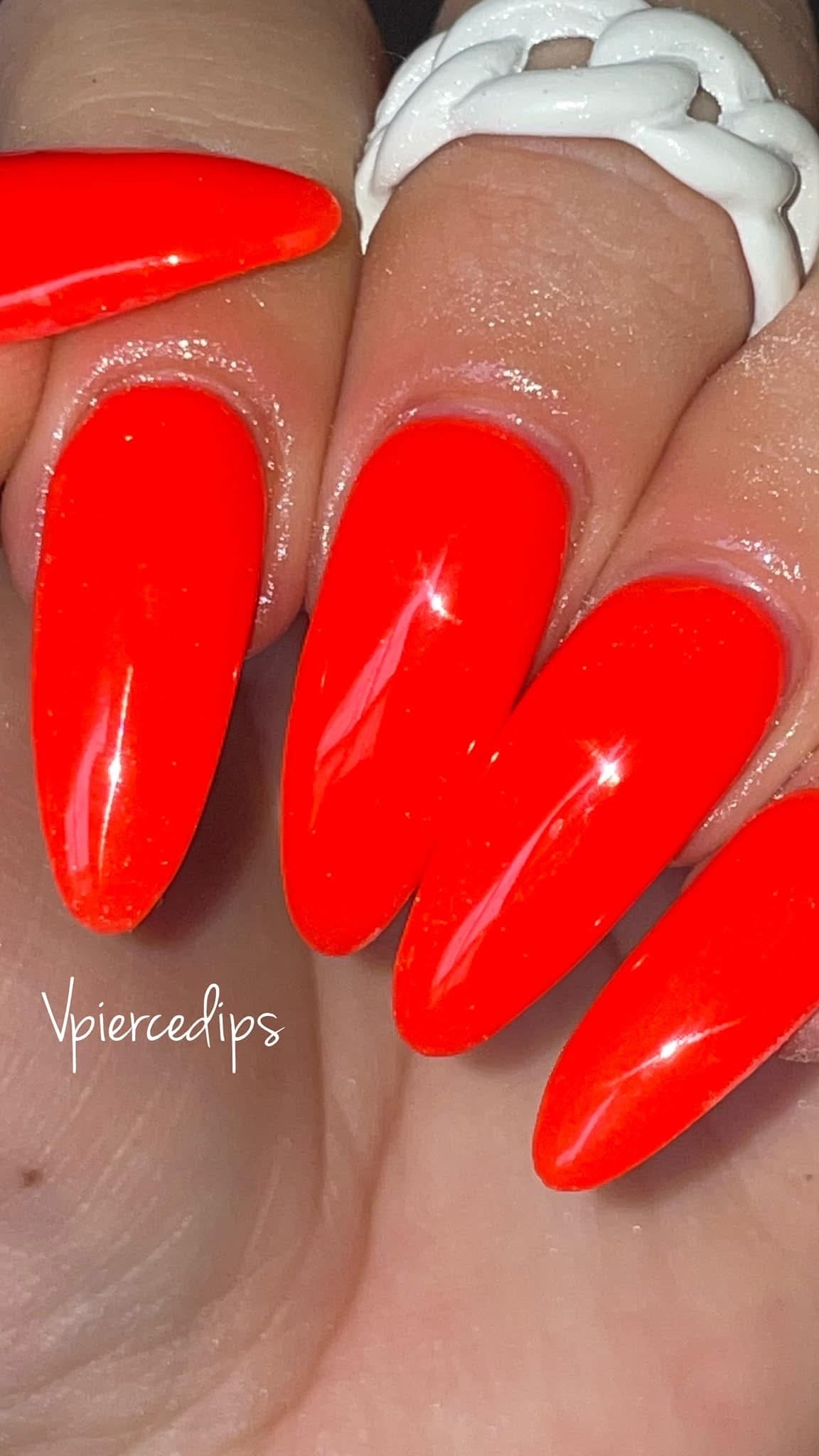 Bright neon orange glossy long coffin-shaped nails with a smooth finish.