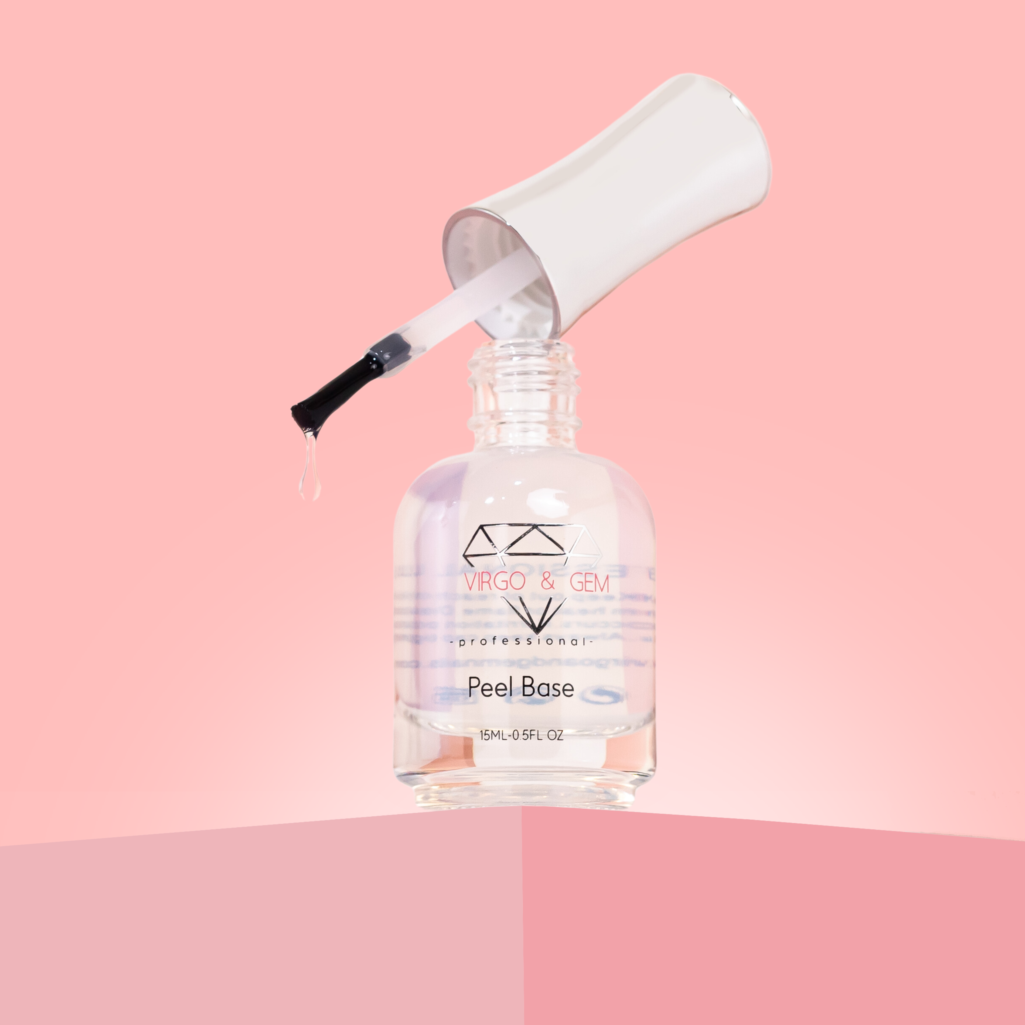 Clear nail polish bottle labeled Peel Base with open white cap and brush dripping liquid on pink background.