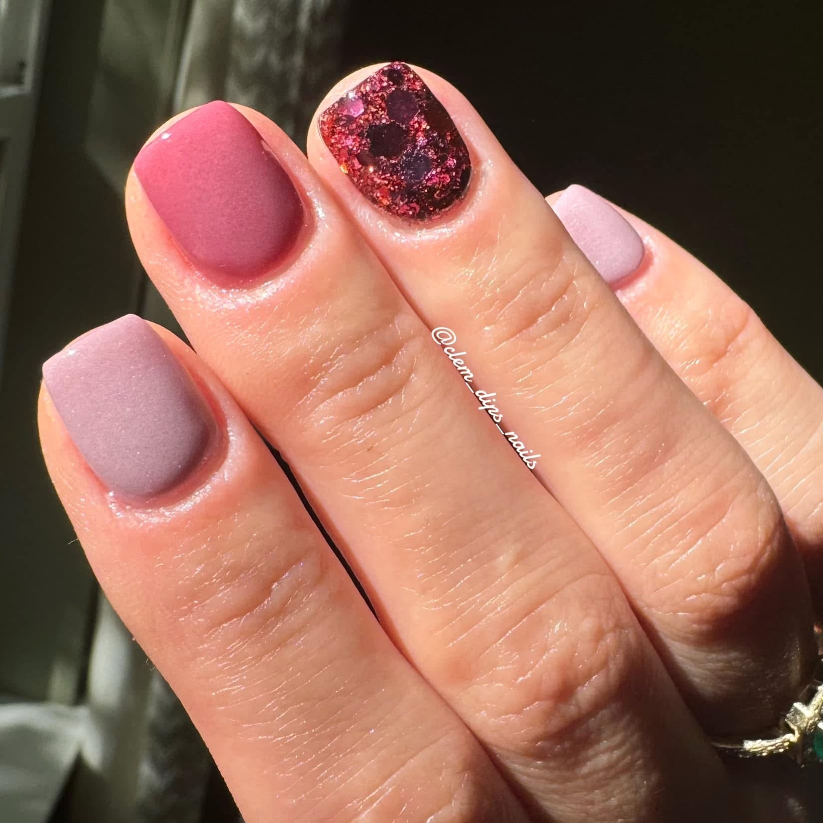 Matte mauve, dusty pink, and glossy red glitter dip powder nails on short natural nails.