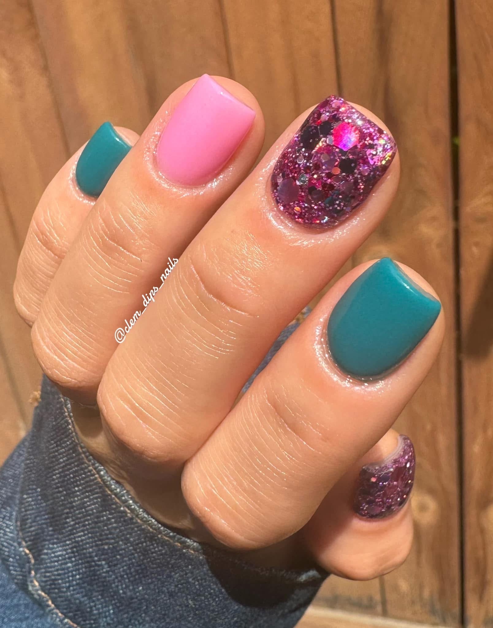 Manicure with teal solid color, pink solid color, and glittery pink-purple nail polish on short nails.