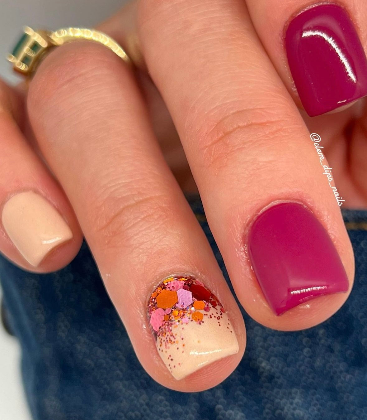 Multicolor chunky glitter accent nail with cranberry pink and beige solid colors on short square nails.