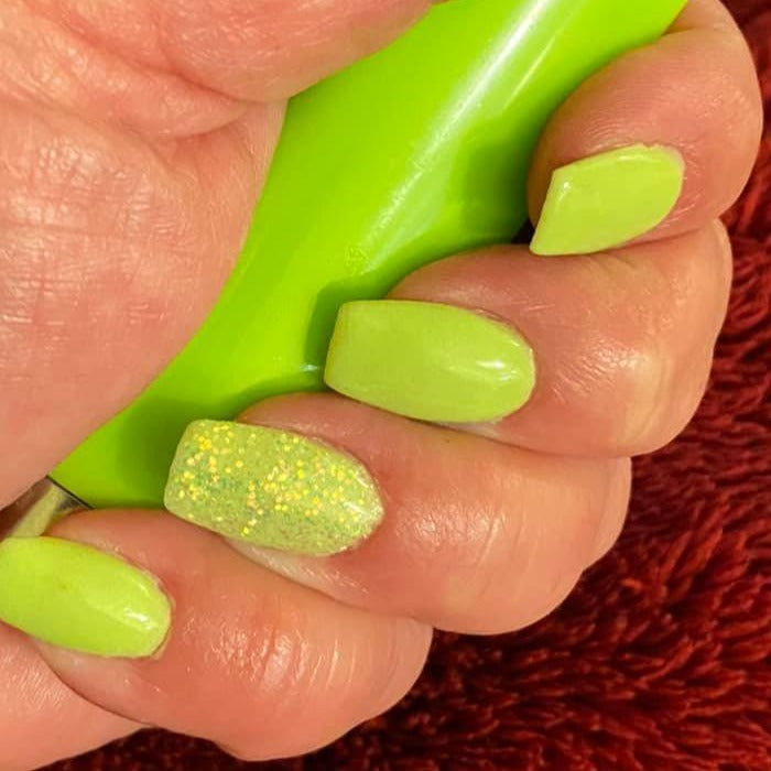 Neon green dip powder nails with glitter accent on ring finger, square shape, glossy finish.