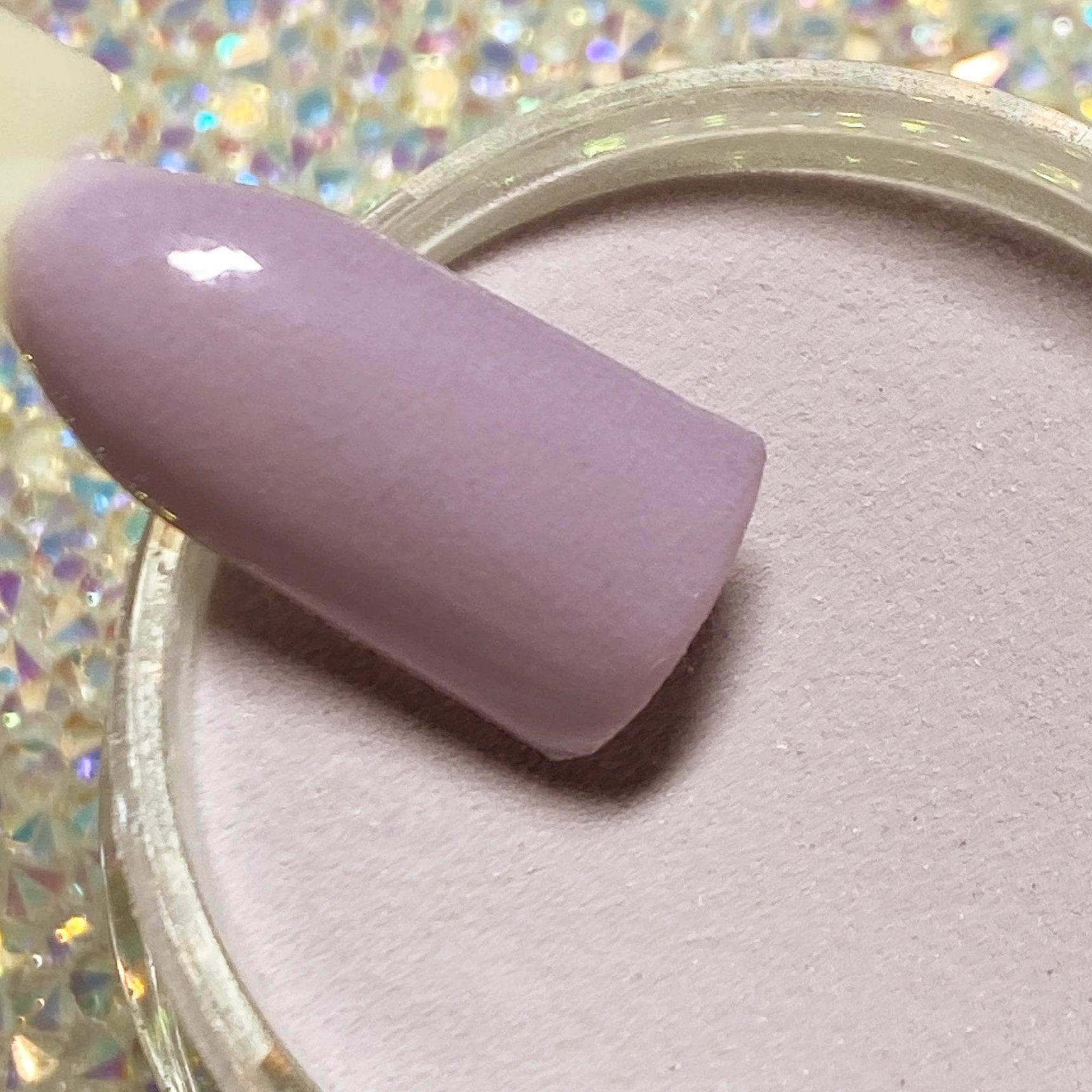 Lilac purple solid dip powder nail color with smooth matte finish on display stick.