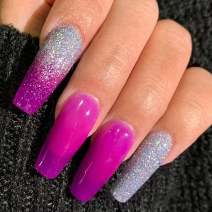 Long coffin nails with glittery light blue and shiny purple color-changing dip powder polish.