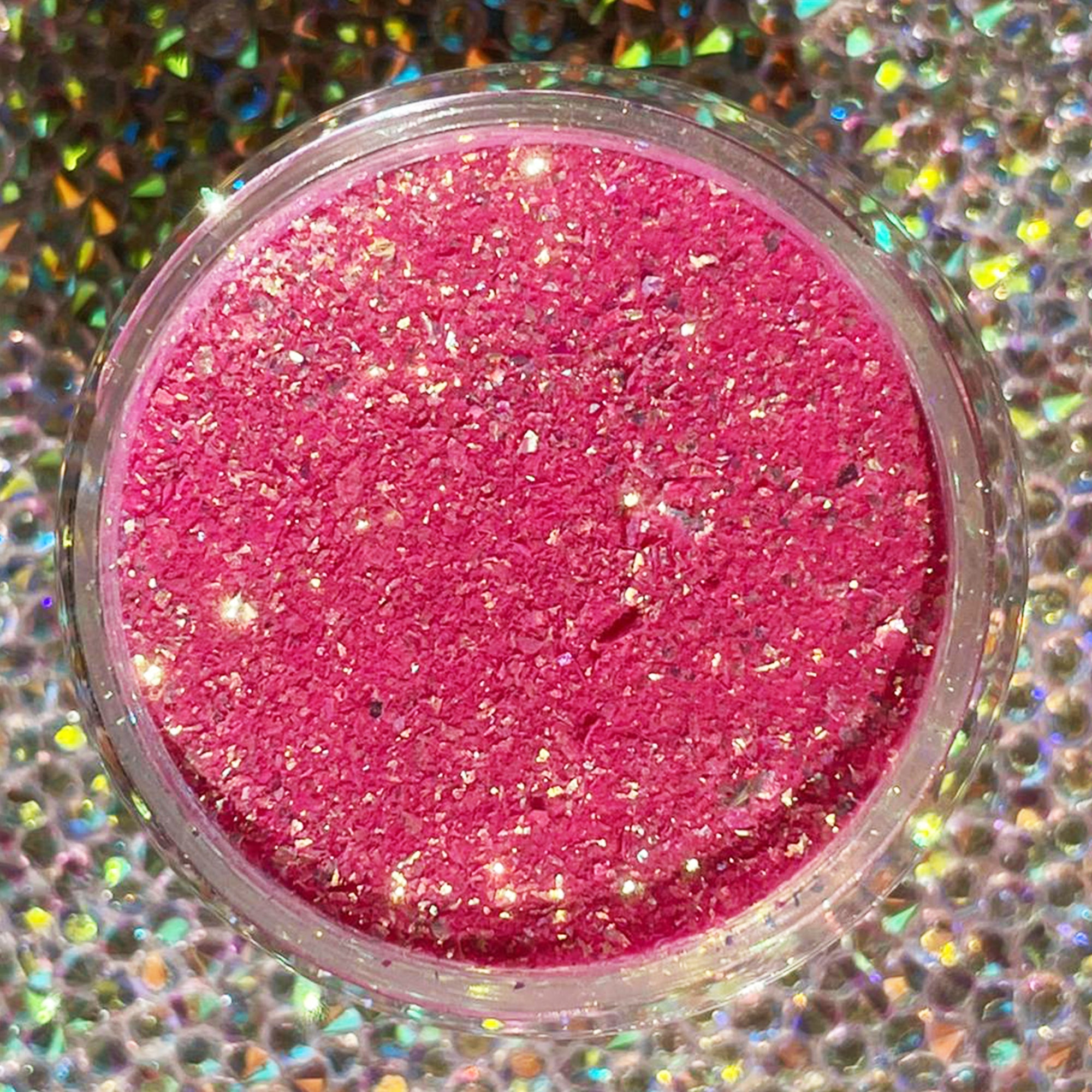Bright pink chameleon flake glitter dip powder with multicolor shimmer in a clear round container.