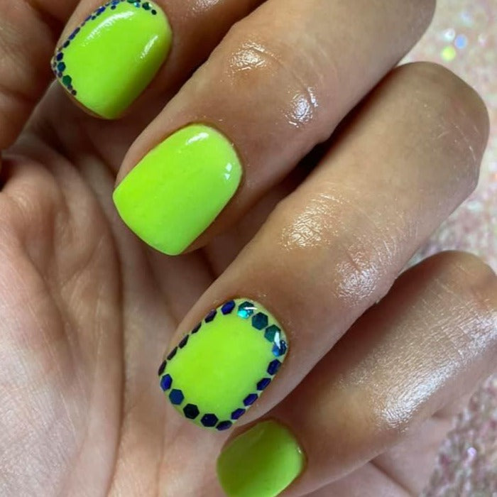 Neon green solid dip powder nails with iridescent blue dot accents on square tips.