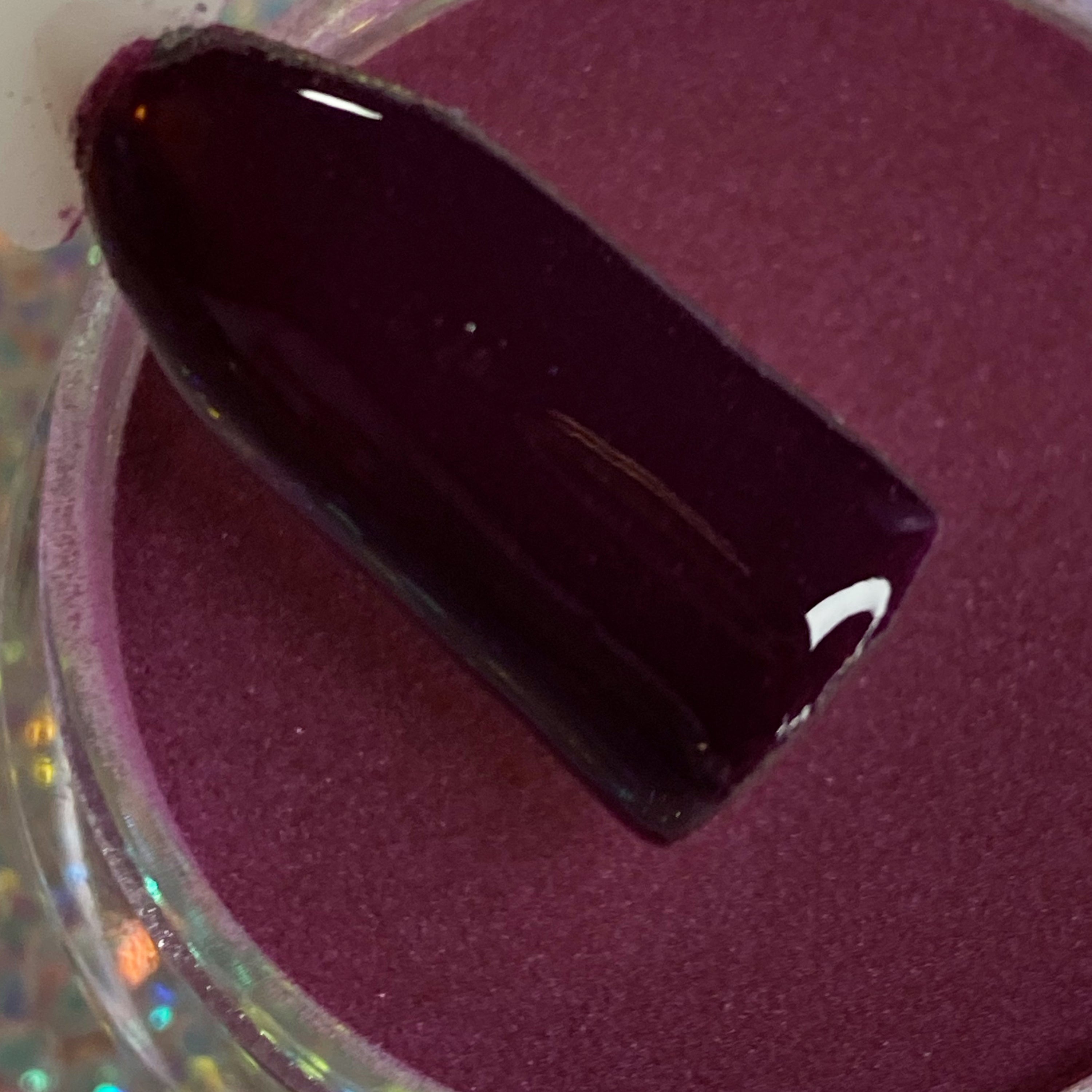 Dark purple solid dip powder labeled DP30 Wine Not in clear round container with swatch stick.