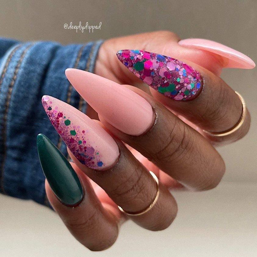 Long stiletto nails with teal, matte pink, and chunky multicolor glitter polish designs.