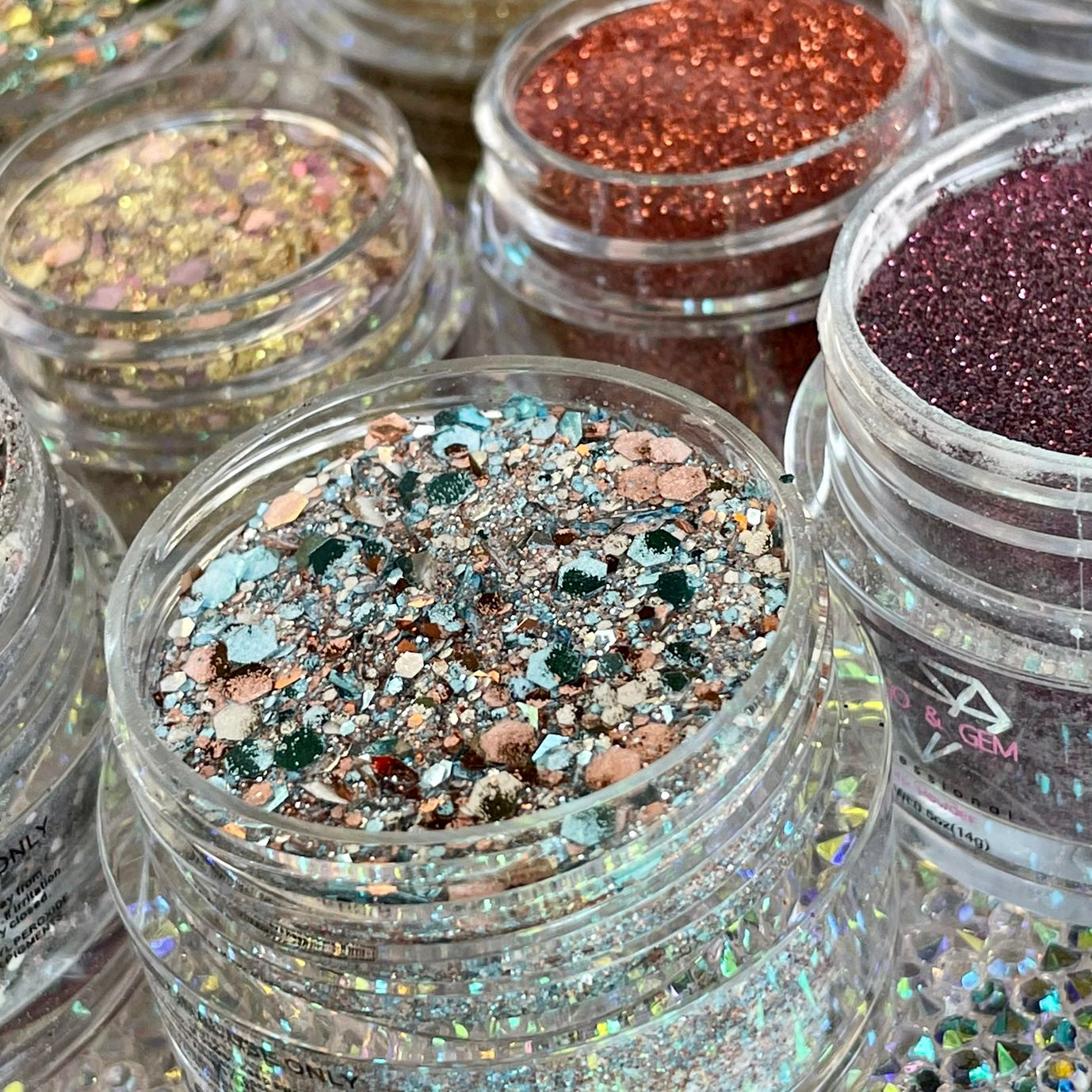 Chunky glitter mix with blue, copper, silver, and multicolor flakes in clear container.