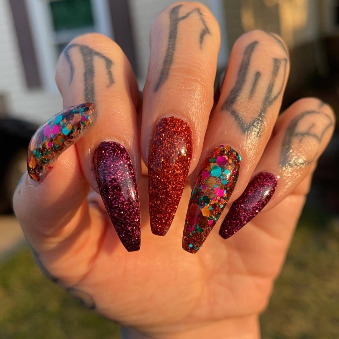 Long coffin-shaped nails with deep berry toffee chunky glitter dip powder and multicolor glitter accents on ring and thumb.