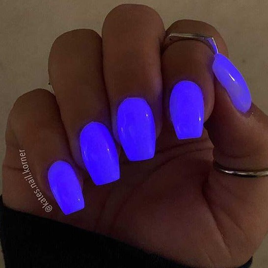 Purple glow-in-the-dark nails with a smooth, glossy finish on square-shaped tips.