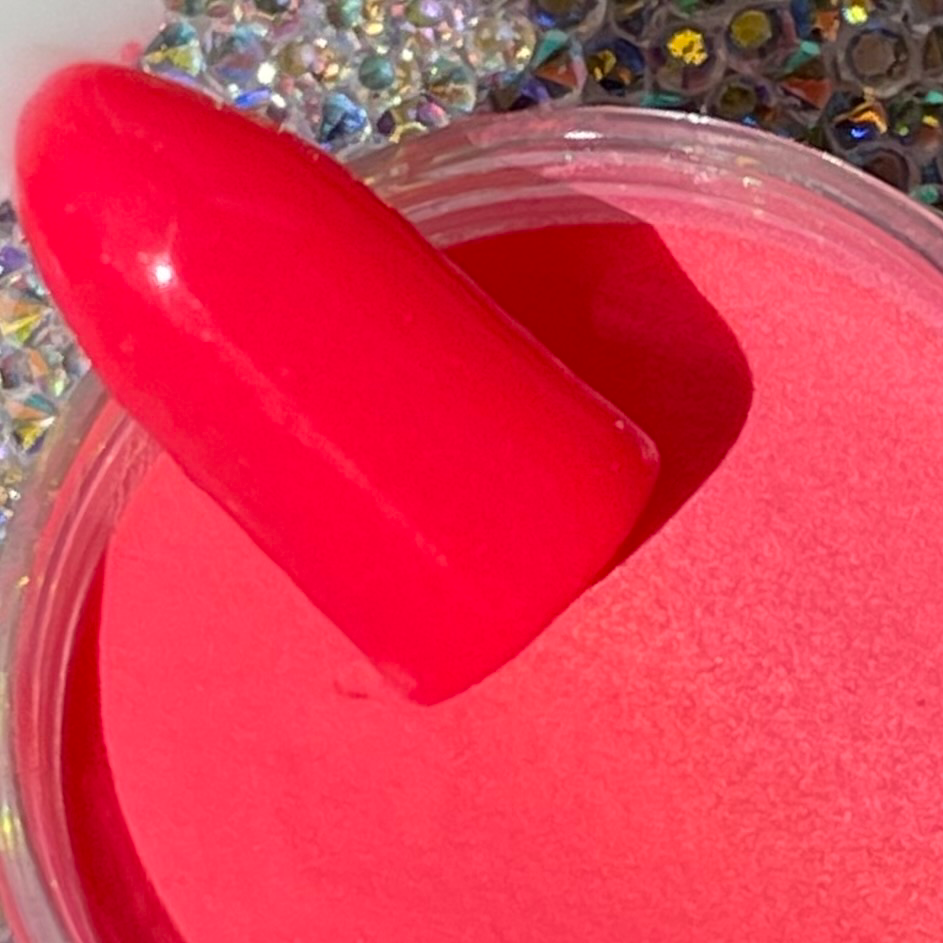 Bright pink dip powder nail color with glossy finish in open container labeled DP143 Fire Island.