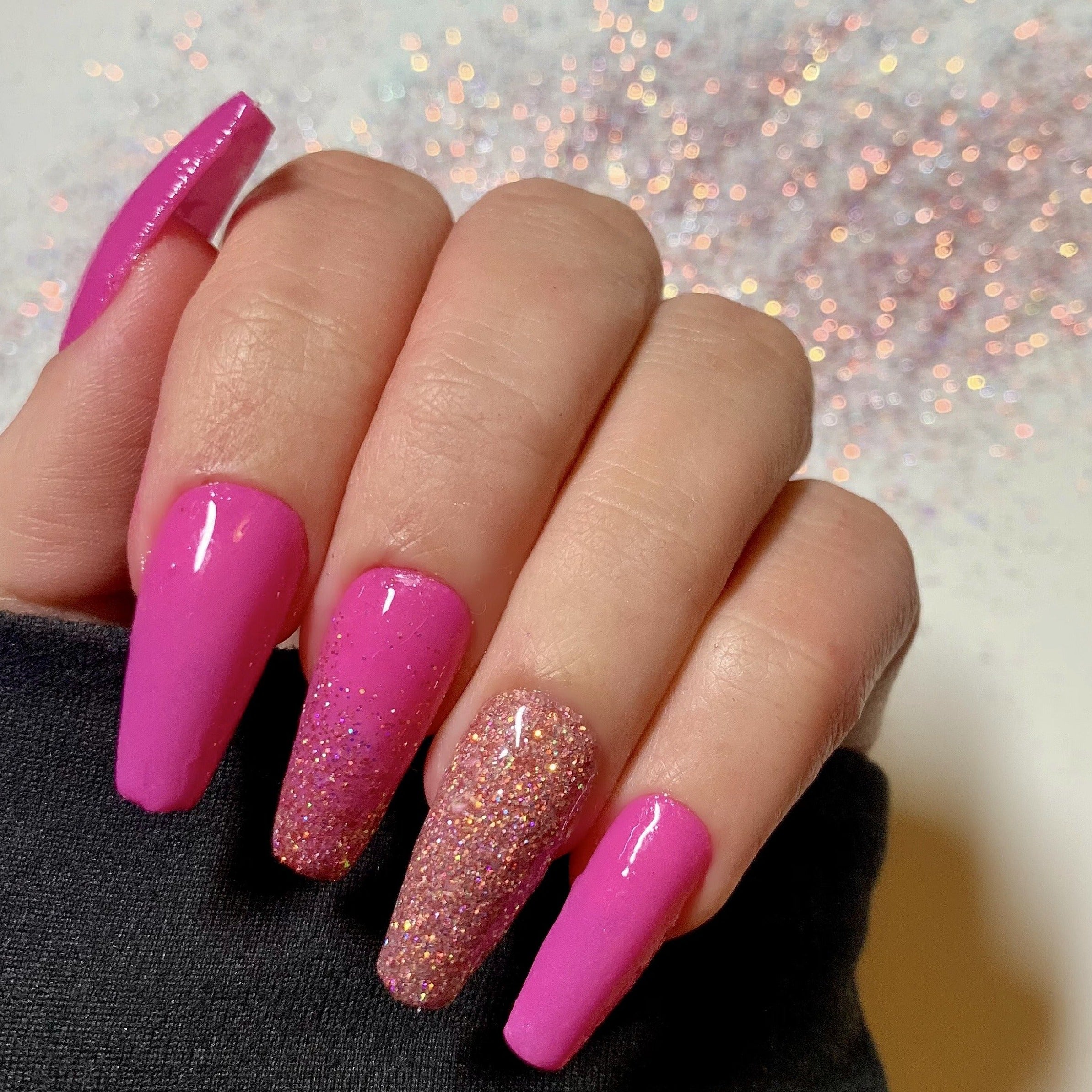 Bright pink thermal dip powder nails with glitter accent ring finger and coffin shape.