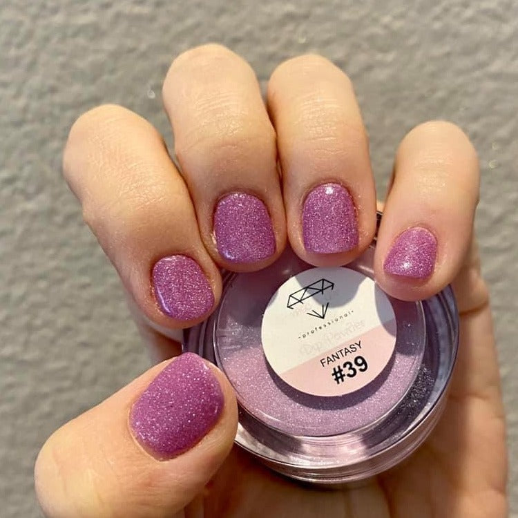 Purple fine glitter dip powder manicure with a shimmering textured finish on short nails.