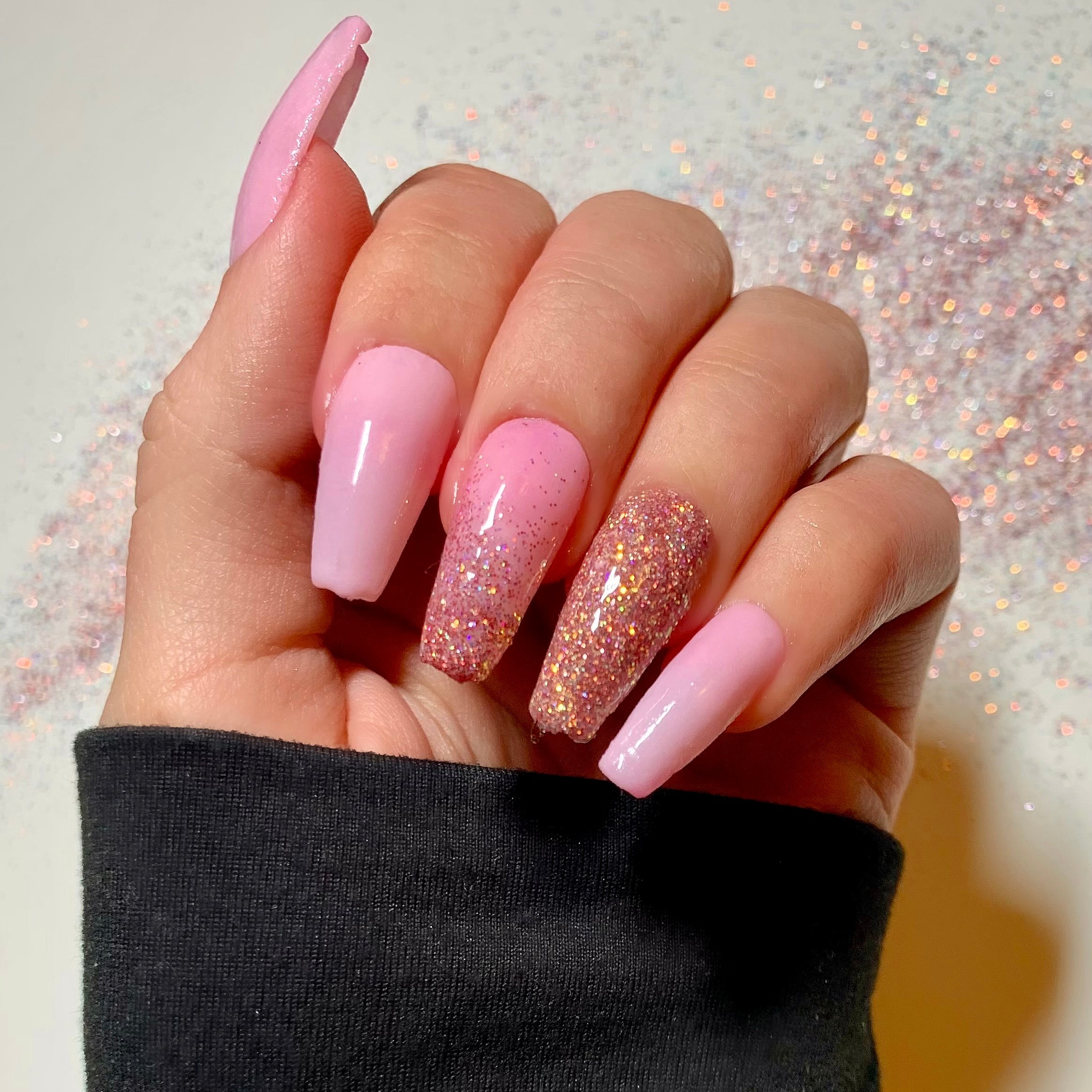 Long coffin-shaped nails with pink to glittery gold thermal color changer dip powder polish.