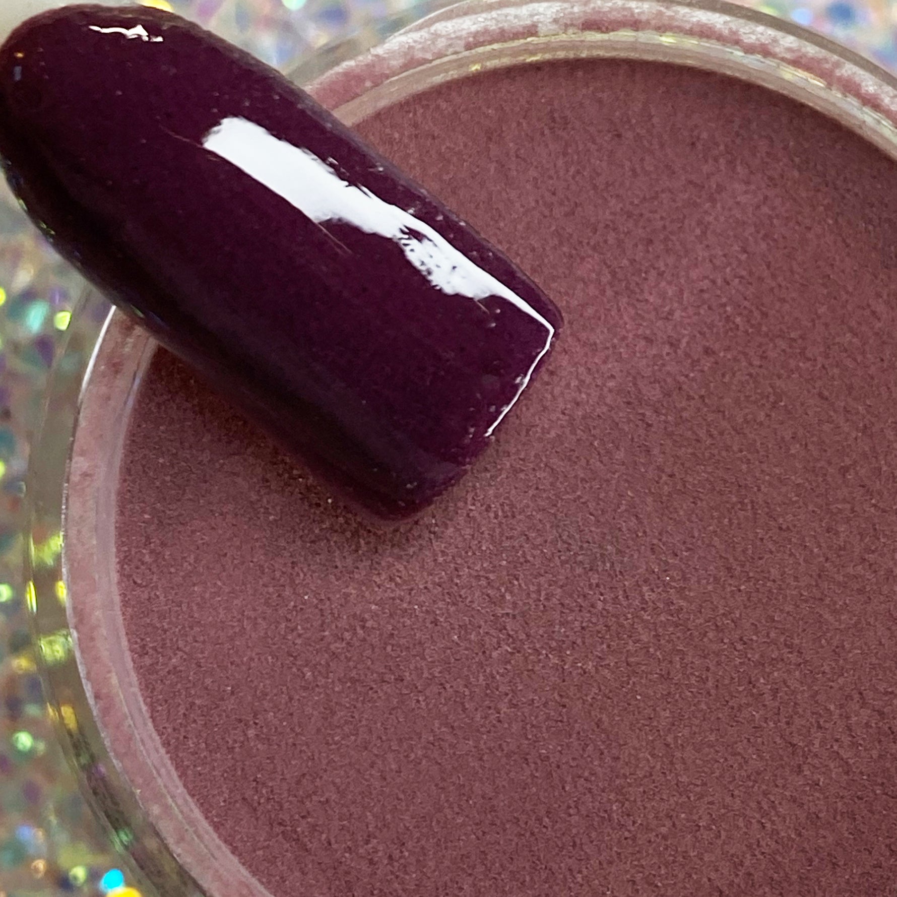 Deep wine purple dip powder with smooth, glossy finish on nail swatch.