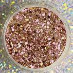 Chunky pink, gold, and rose gold glitter dip powder with mixed-size sparkles in clear round container.