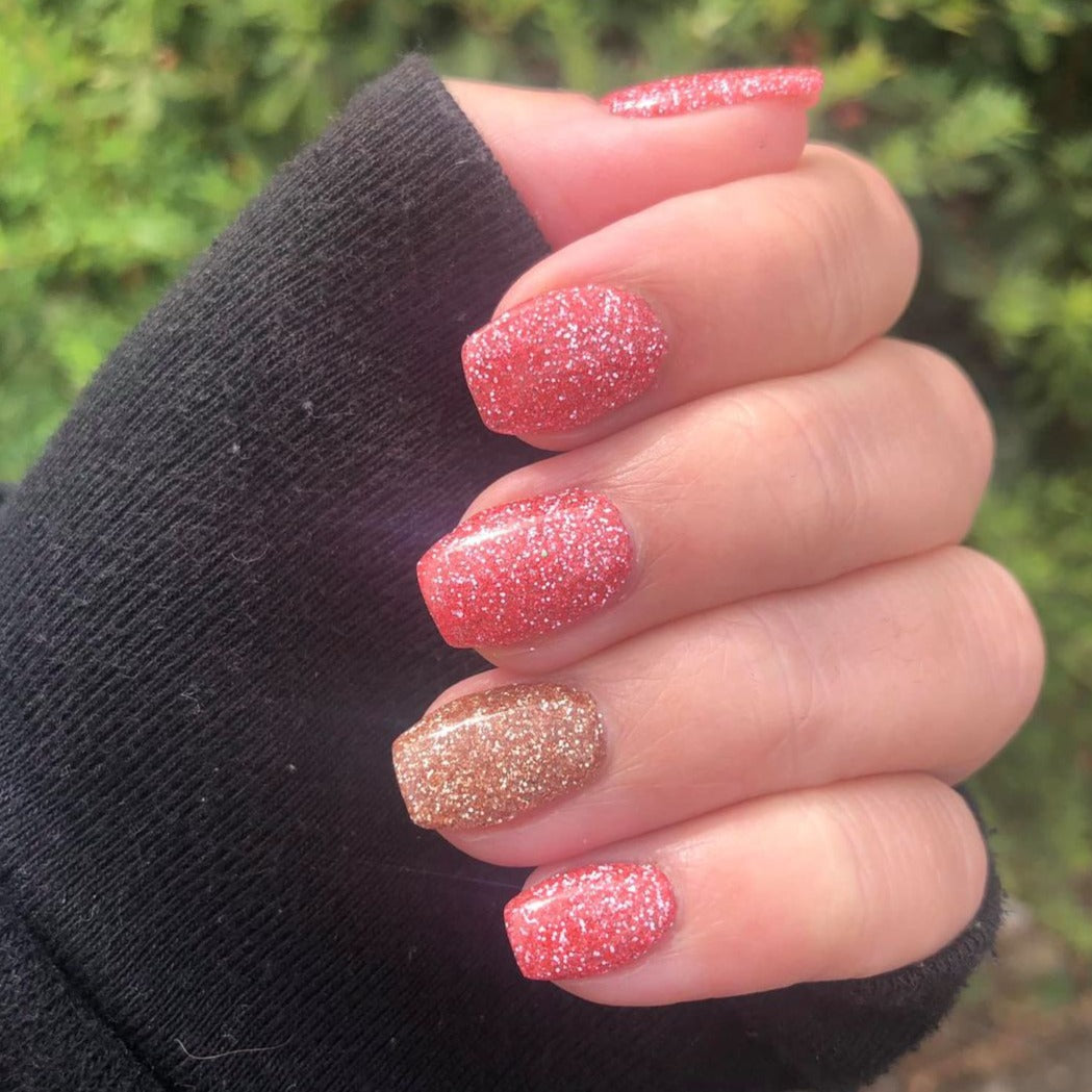 Pink and rose gold glitter dip powder nails with fine sparkle finish on short nails.