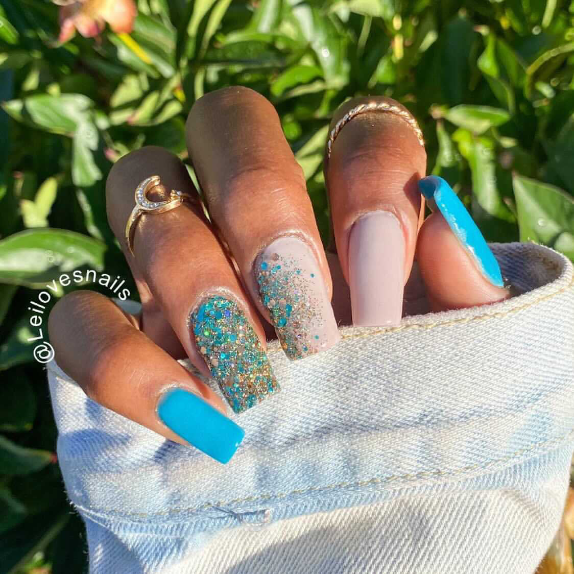 Manicure with matte bright blue, light pink, and chunky multicolor glitter dip powder nails.
