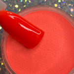 Bright neon orange glow-in-the-dark dip powder with matching glossy swatch stick.