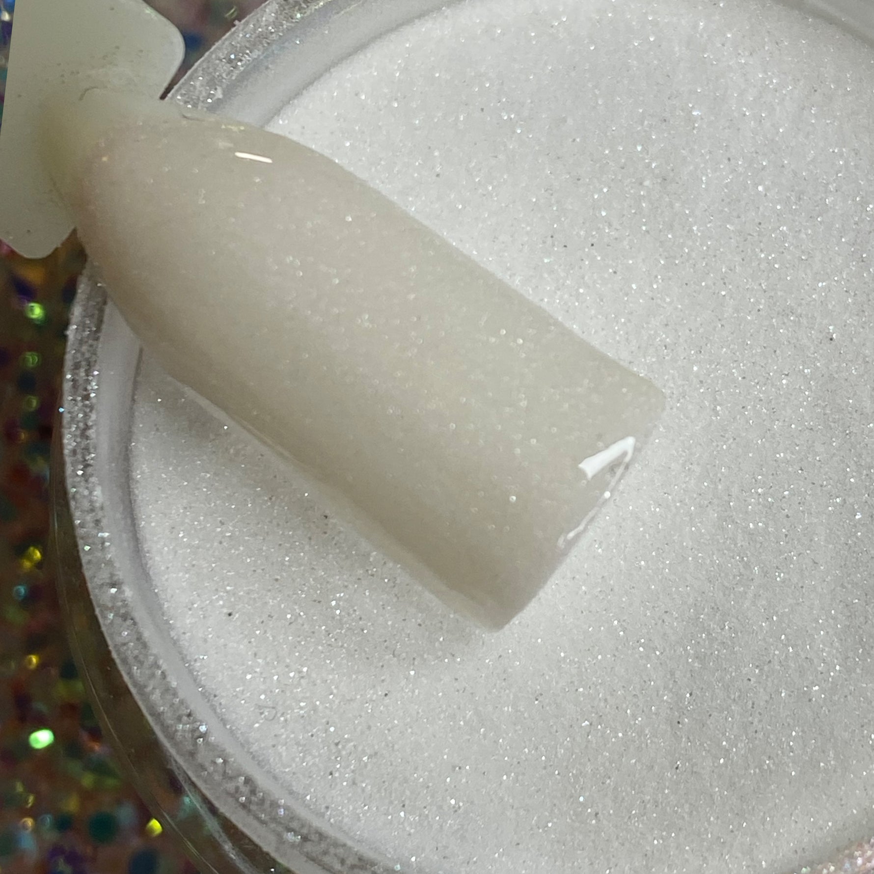 Fine white shimmer dip powder with subtle glitter, smooth texture, labeled DP59 Moonlight.