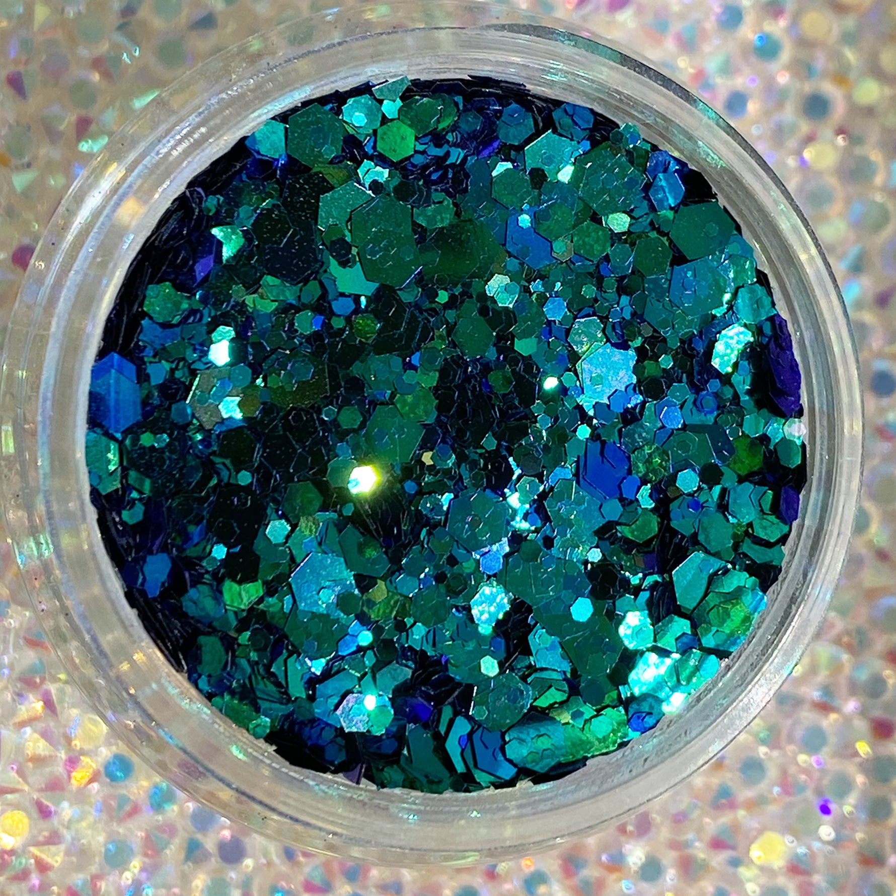 Blue and green chunky glitter mix with iridescent sparkle in clear container.