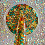 Multicolor chunky glitter mix in orange, blue, yellow, and gold in clear container.