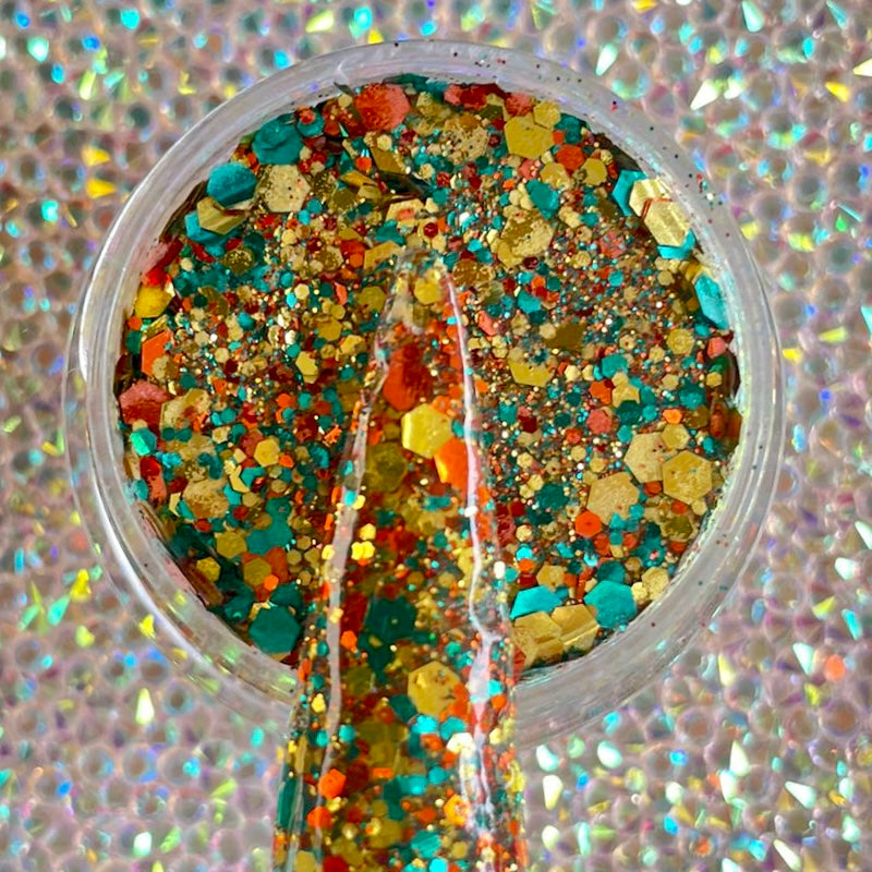 Multicolor chunky glitter mix in orange, blue, yellow, and gold in clear container.