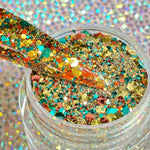 Chunky multicolor glitter dip powder with blue, orange, yellow, and gold flakes in clear jar.