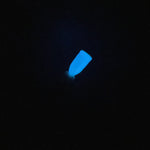 Bright blue neon glow-in-the-dark dip powder swatch on black background.