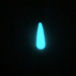 Glowing teardrop-shaped nail tip in bright white-blue glow against black background.