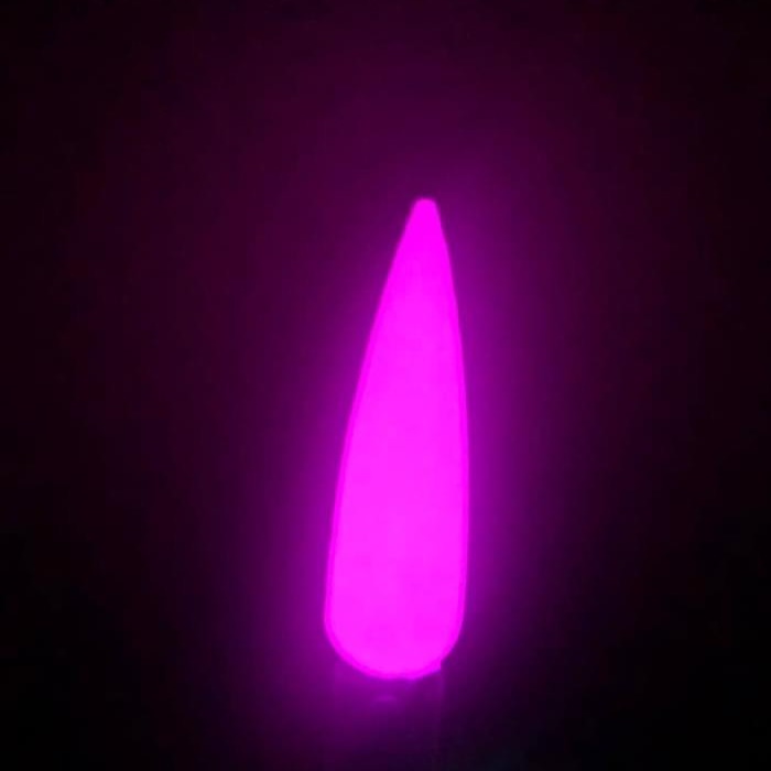 Neon pink glow-in-the-dark nail dip powder swatch on long tapered nail tip.